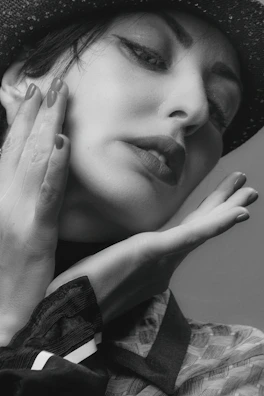 A close-up black and white portrait of Deja Demuré exuding timeless elegance.