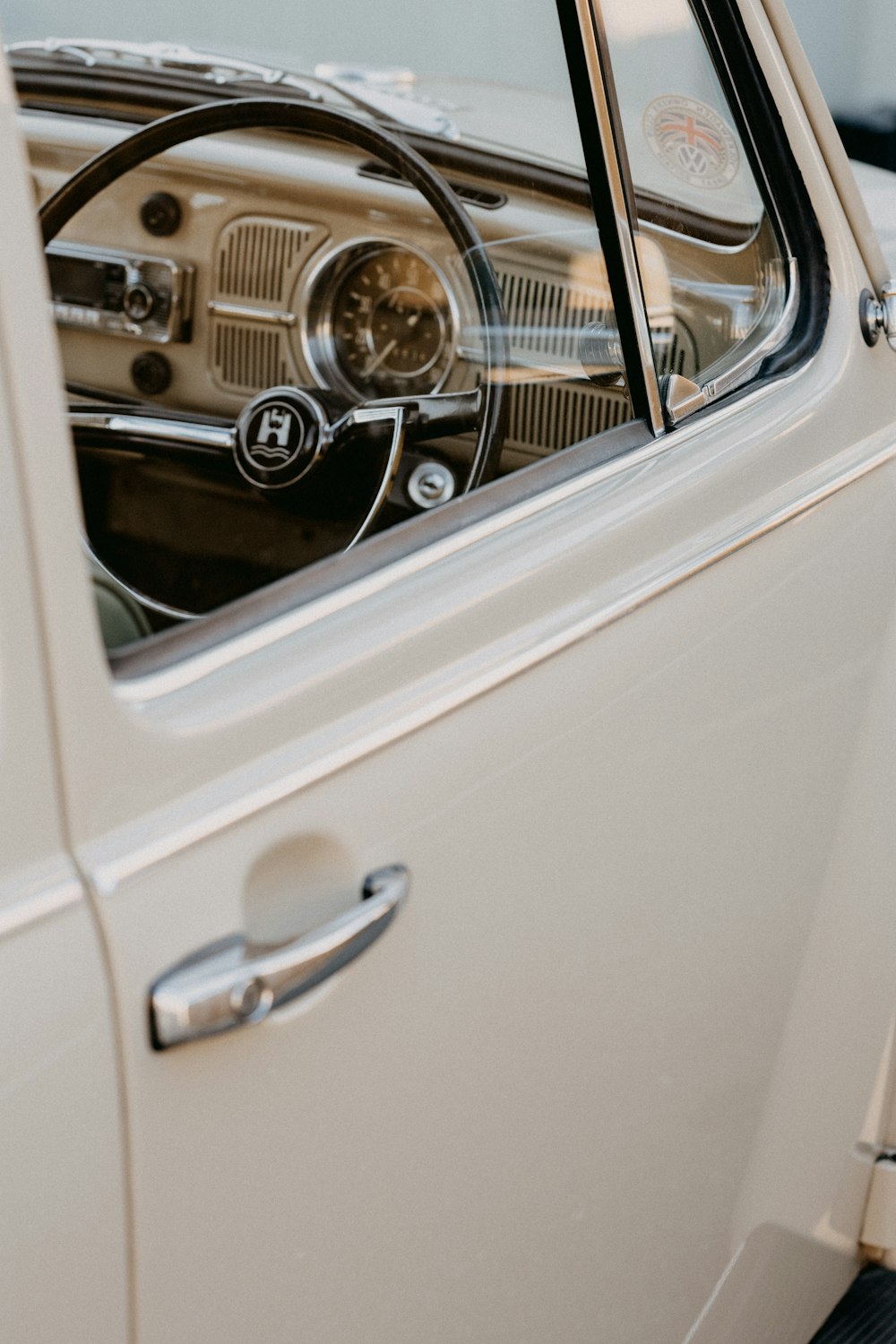 white car with chrome steering wheel