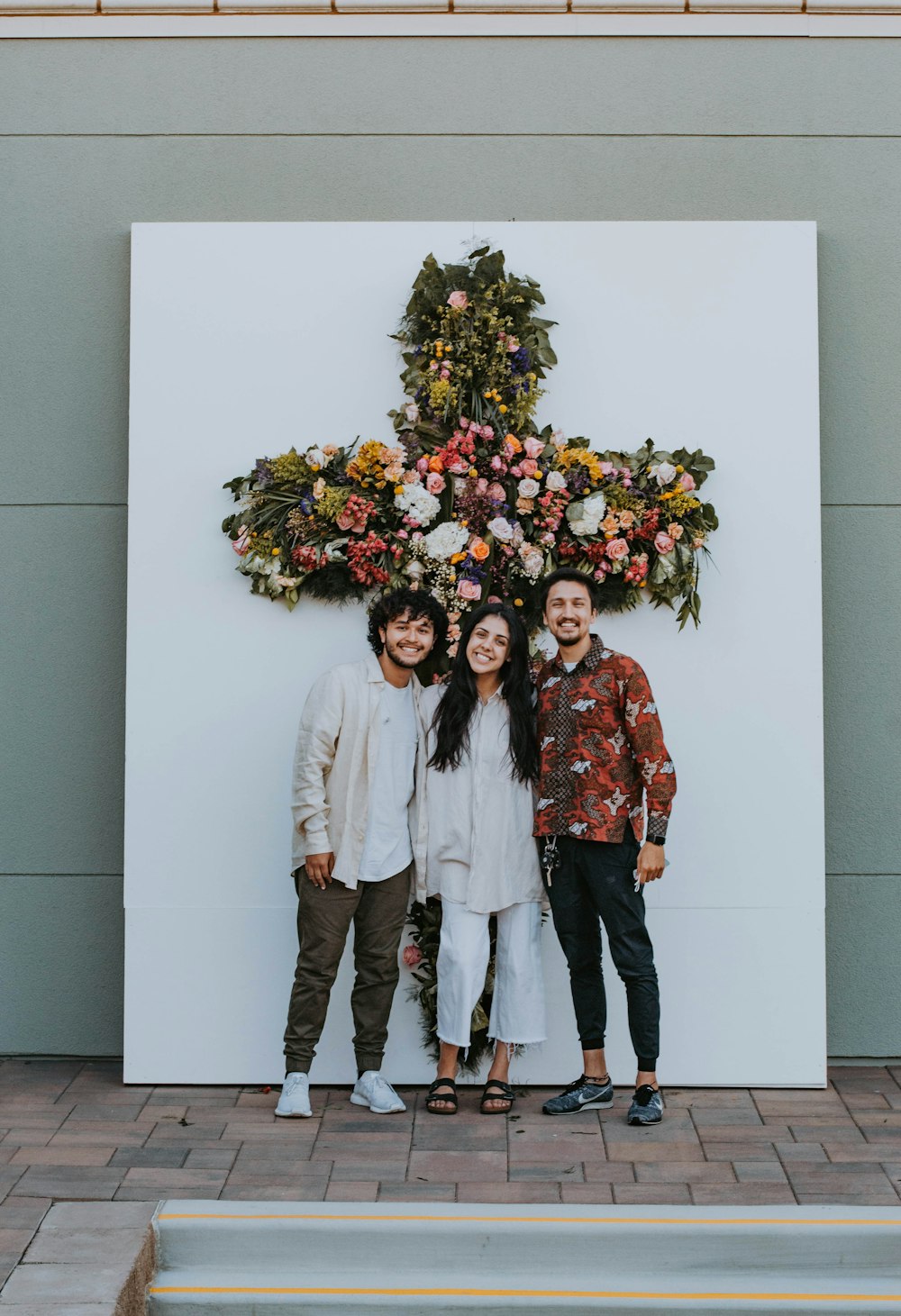 2 women standing beside white wall