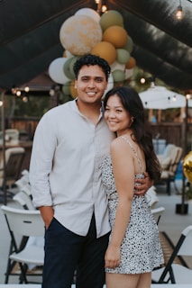 Close-up of a smiling couple holding playful props inside the photobooth.