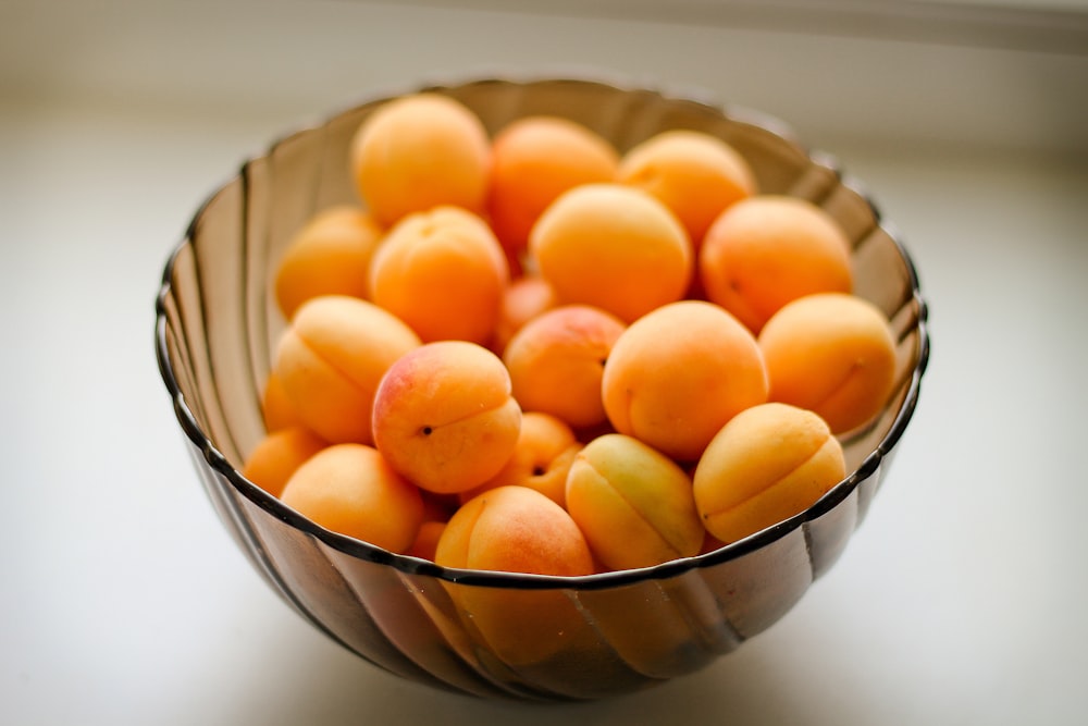 orange fruits in blue ceramic bowl