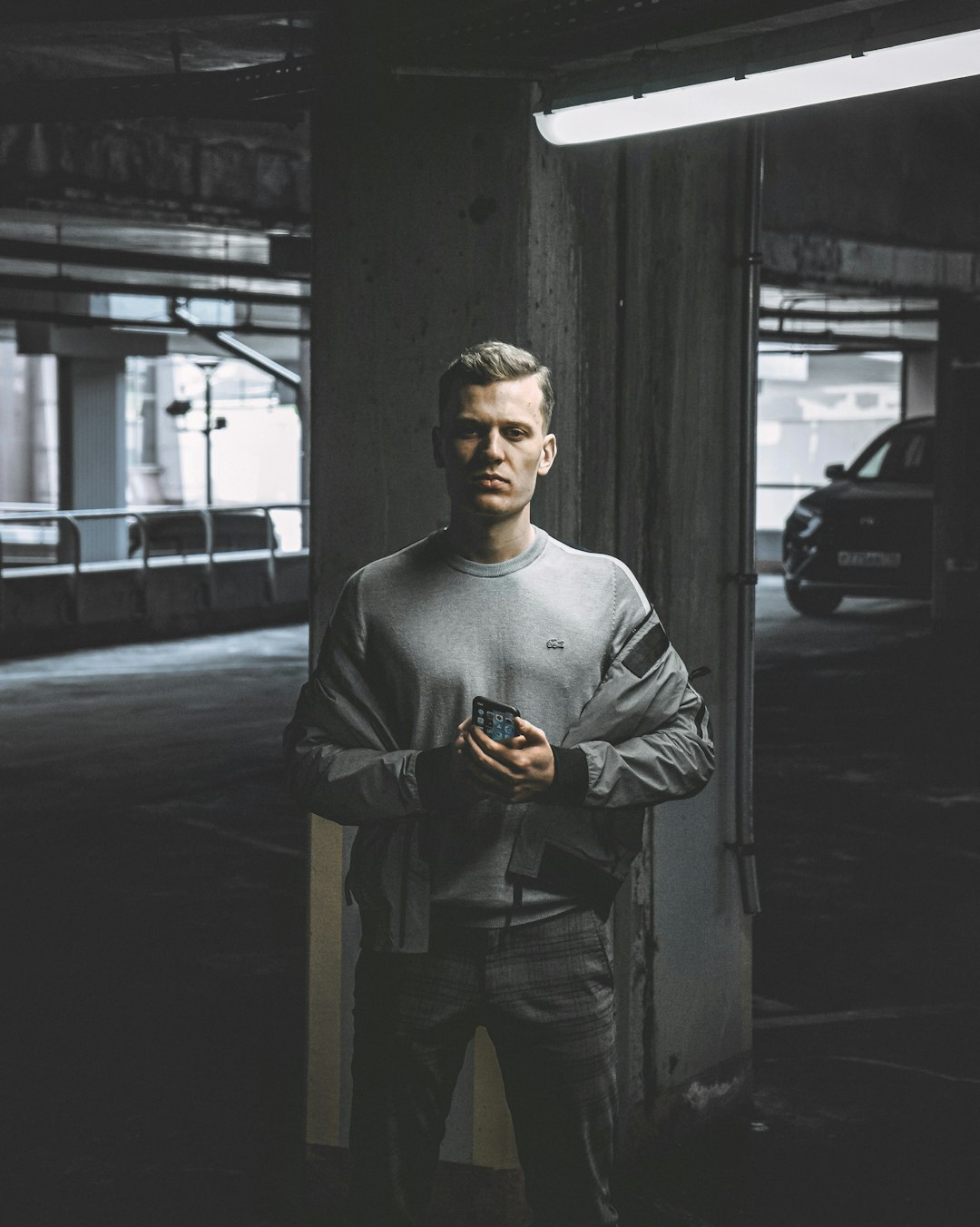 man in black sweater and brown pants holding brown cup