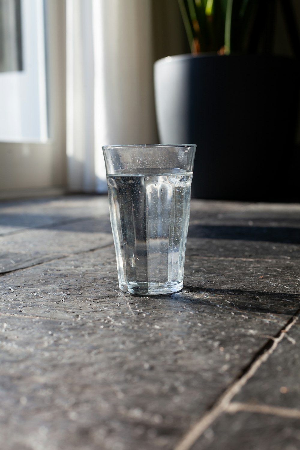 clear drinking glass on brown wooden table