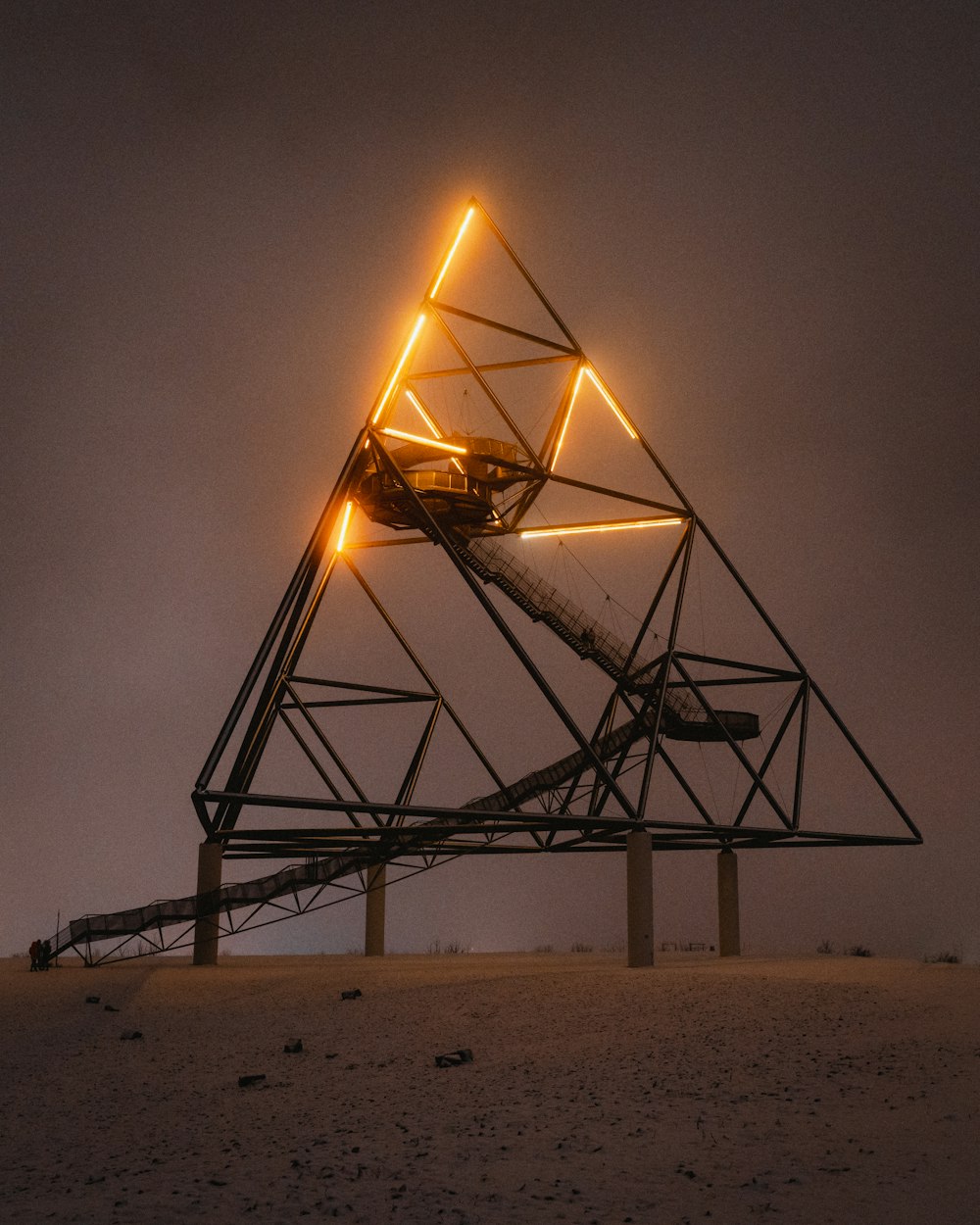 black metal frame on brown sand during night time