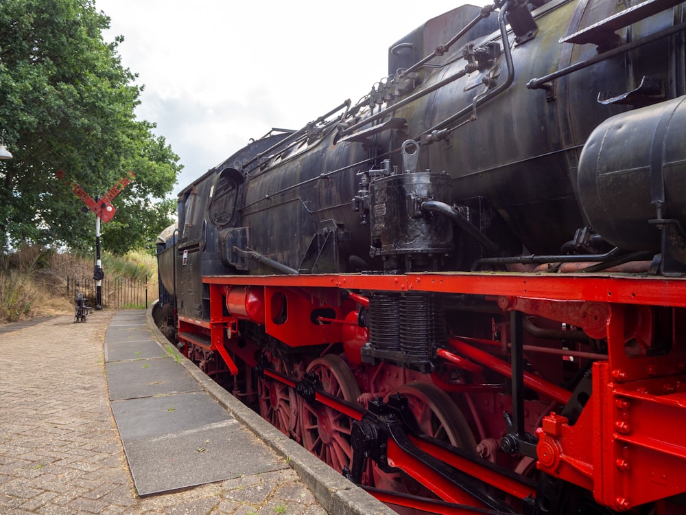 red and black train on rail road during daytime