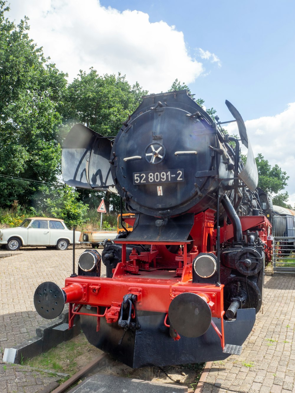 black and red train on rail road during daytime