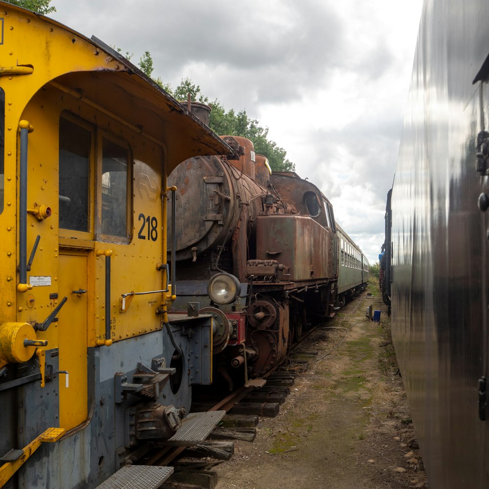 yellow and black train on rail tracks during daytime