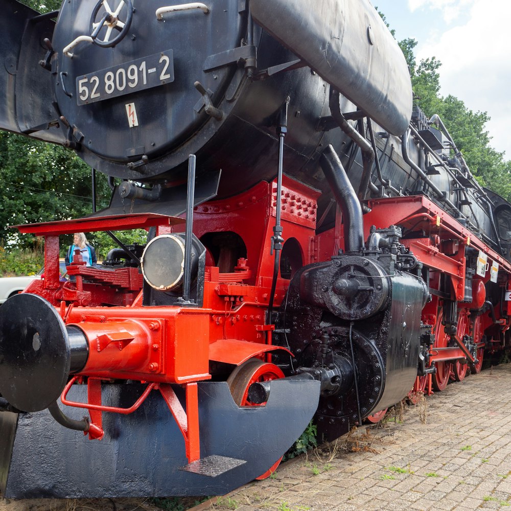 black and red train on rail tracks