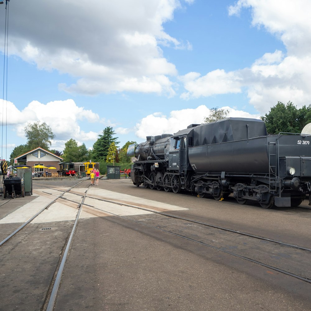 black train on rail road during daytime