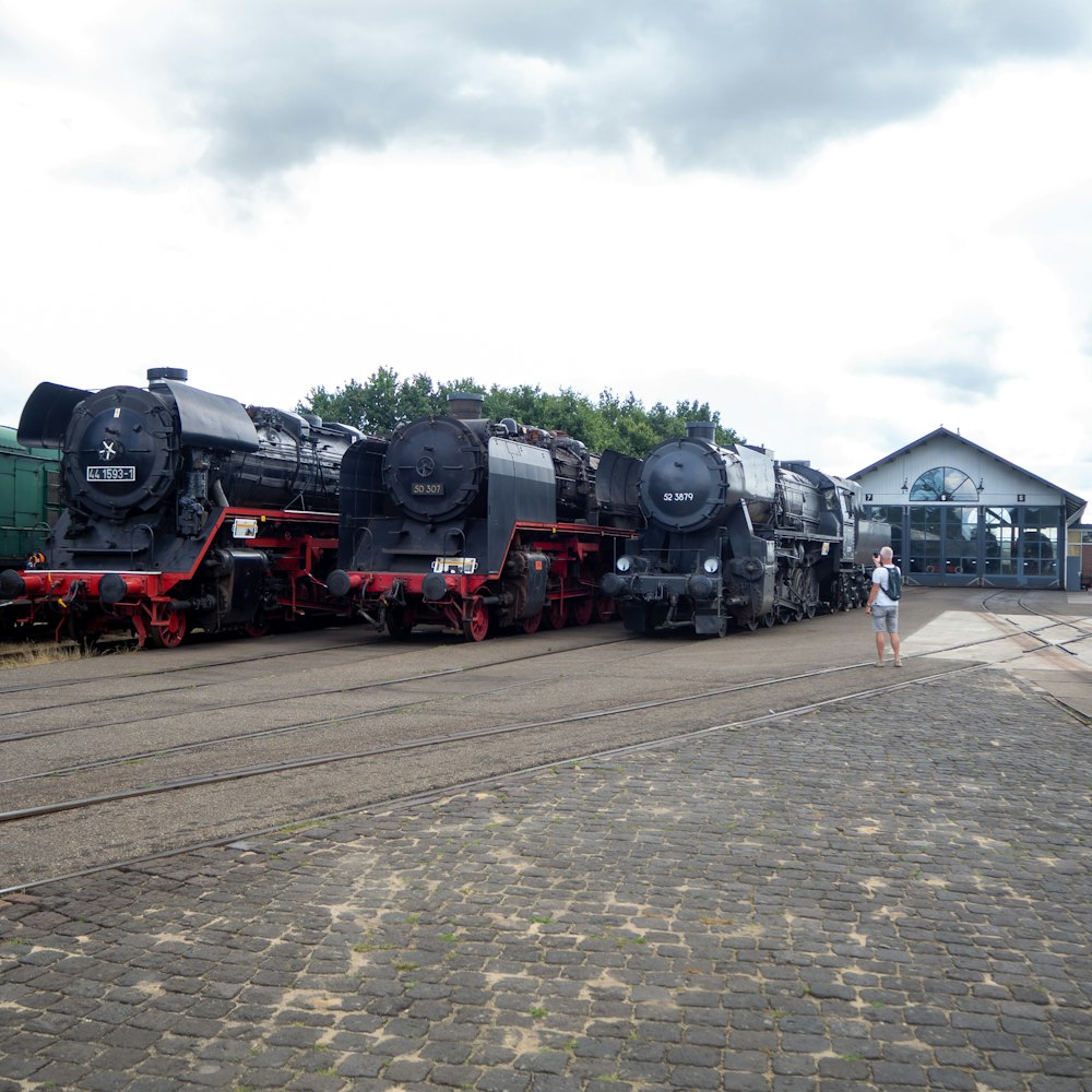 black and red train on rail road during daytime