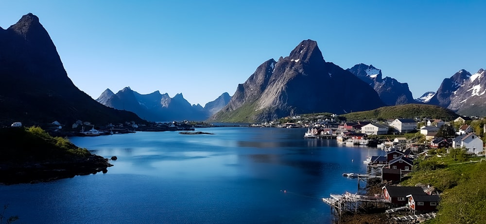 body of water near mountain during daytime