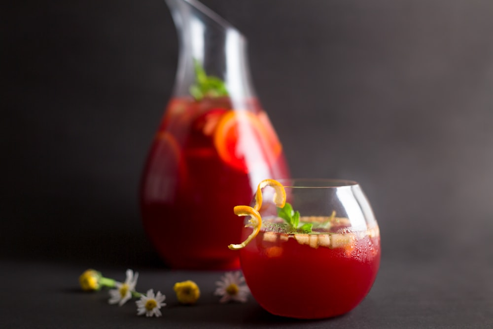 clear drinking glass with red liquid