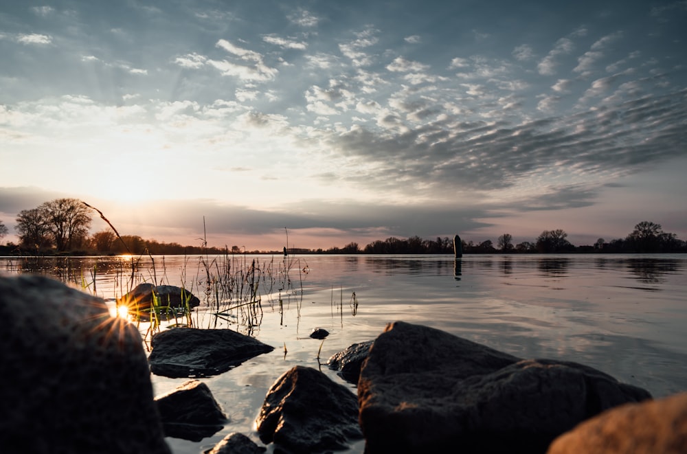 body of water under cloudy sky during daytime