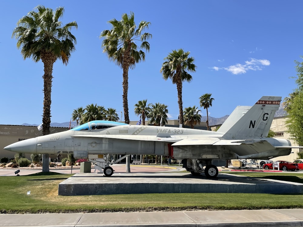 white and blue jet plane on gray concrete pavement during daytime