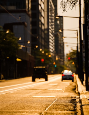 A city street scene at golden hour with vibrant shadows.