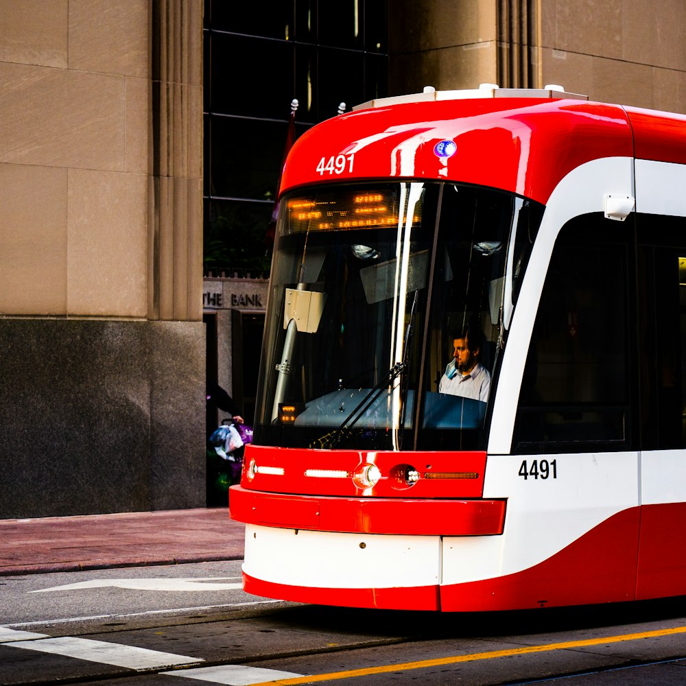 red and white train on the street