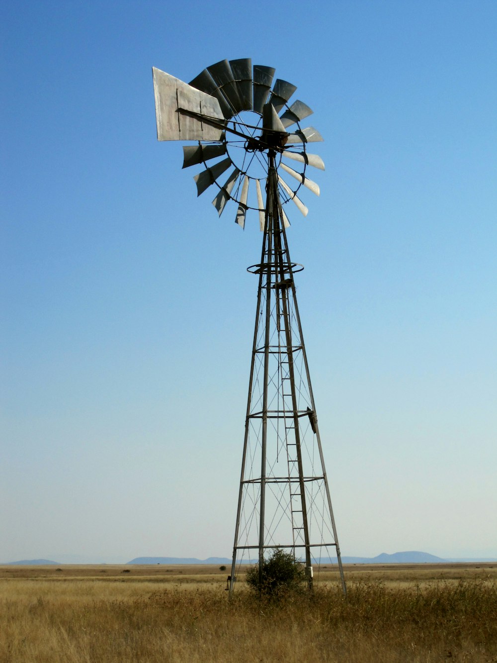 white windmill under blue sky during daytime