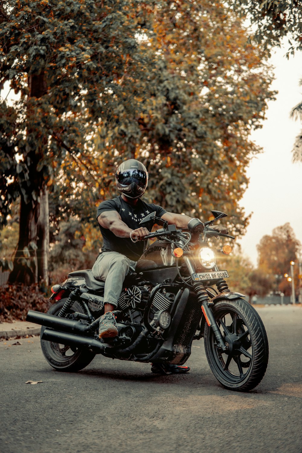 man in brown and green camouflage jacket riding black motorcycle