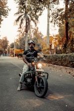 man in black helmet riding motorcycle on road during daytime