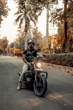 man in black helmet riding motorcycle on road during daytime