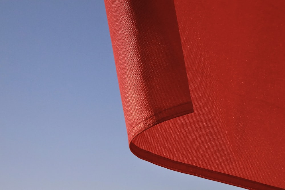 red textile under blue sky during daytime