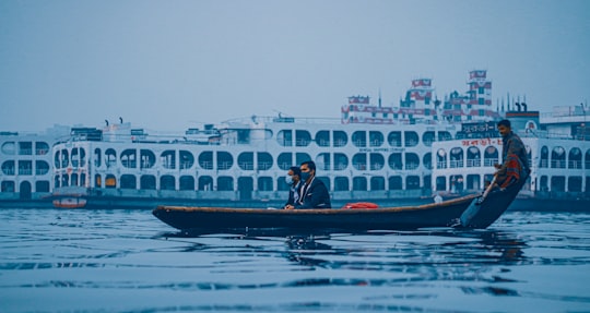 man and woman riding on boat during daytime in Dhaka Bangladesh