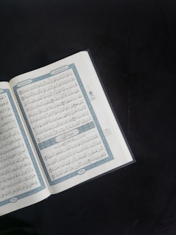 A modern laptop screen showing a beautifully designed Islamic book website.
