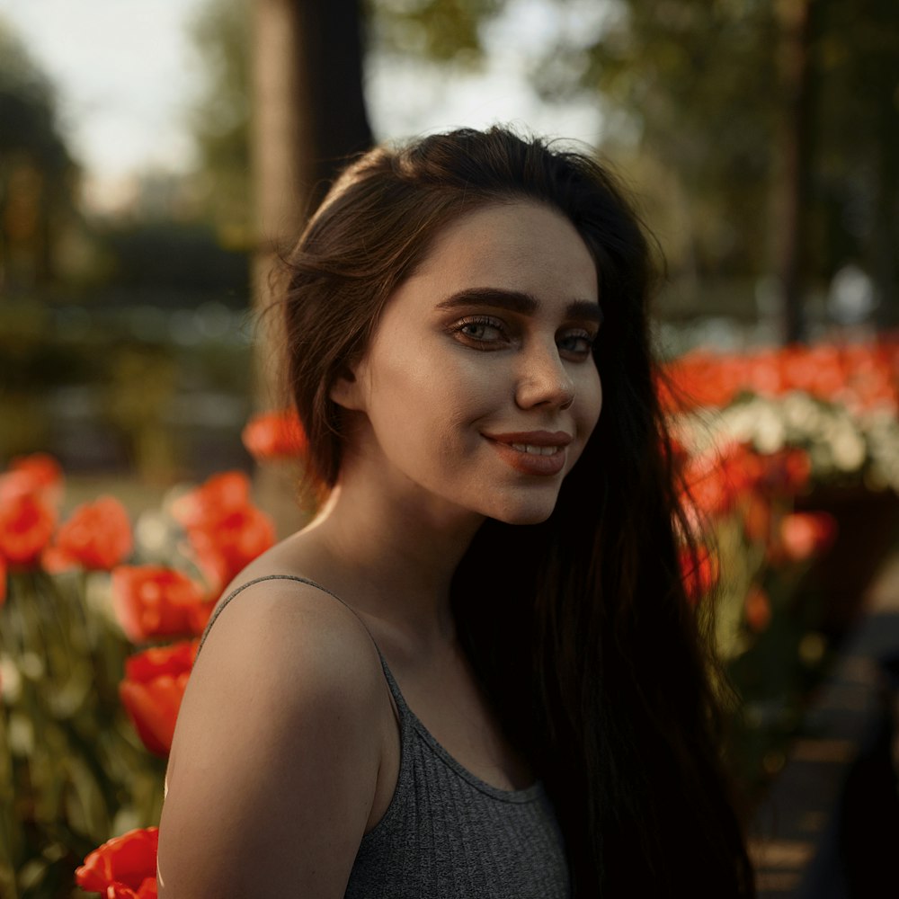 woman in gray tank top smiling