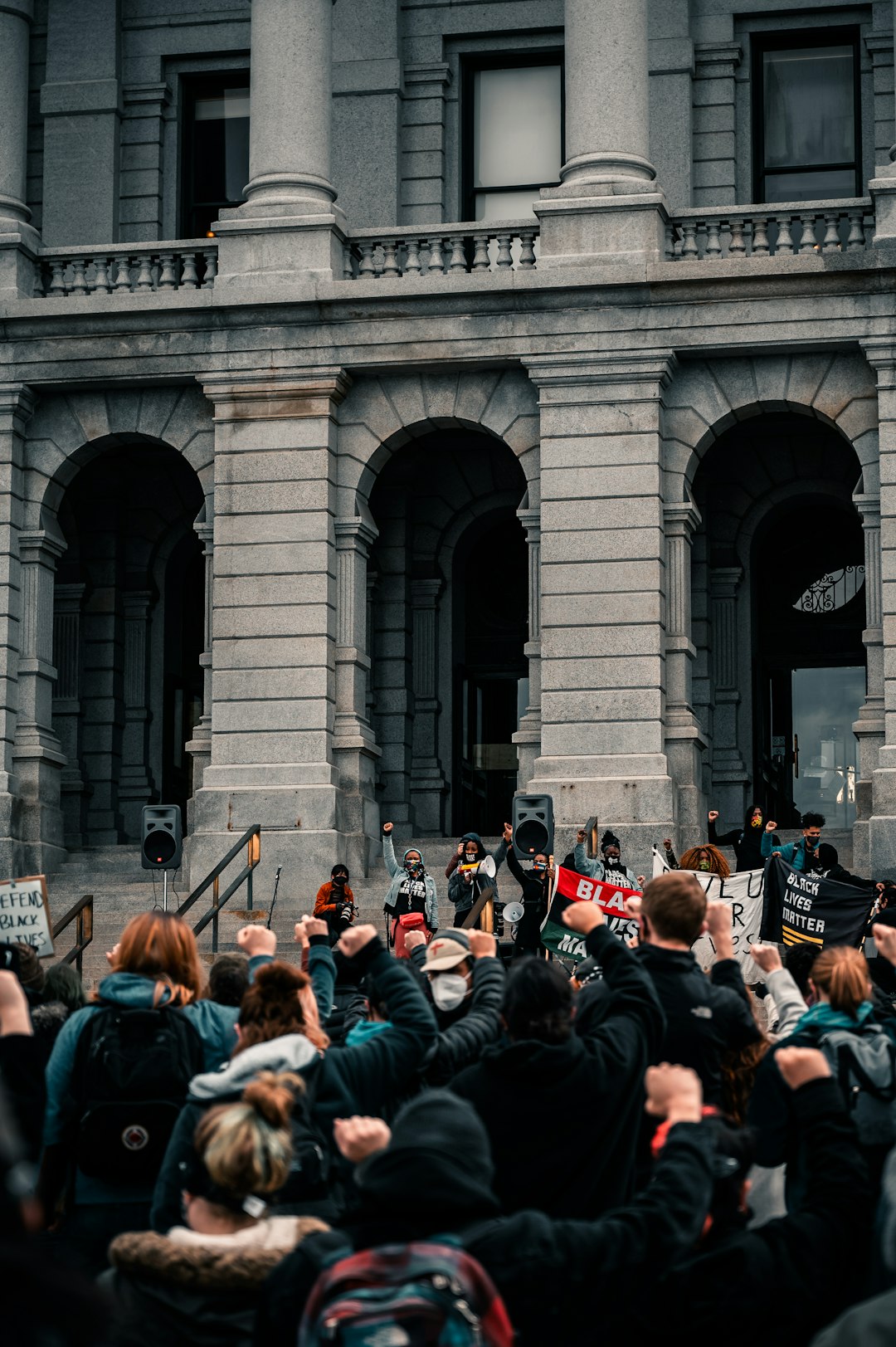 people standing near gray concrete building during daytime