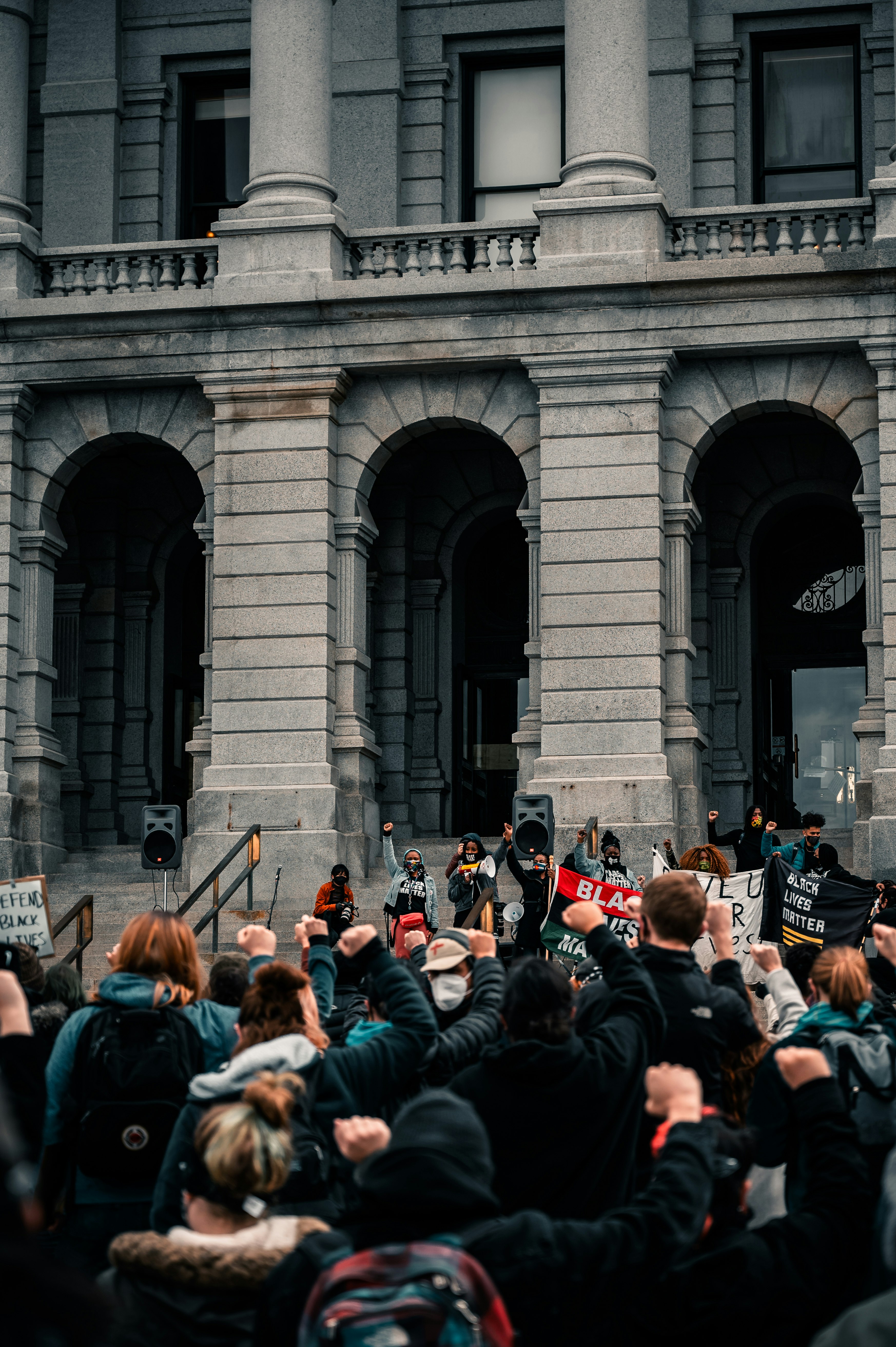 people standing near gray concrete building during daytime