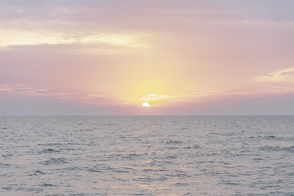 body of water under cloudy sky during daytime