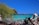 A scenic view of a tropical beach with clear blue water.