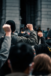 A group of diverse workers united in front of a government building, symbolizing solidarity and strength.