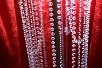 Rows of shimmering glass beads catching light in a vibrant display.