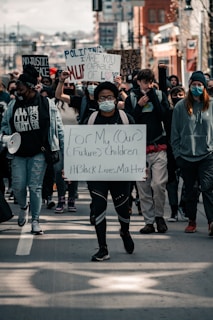 people holding white and black banner
