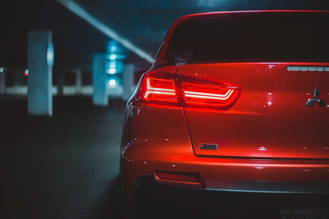 red car on road during night time