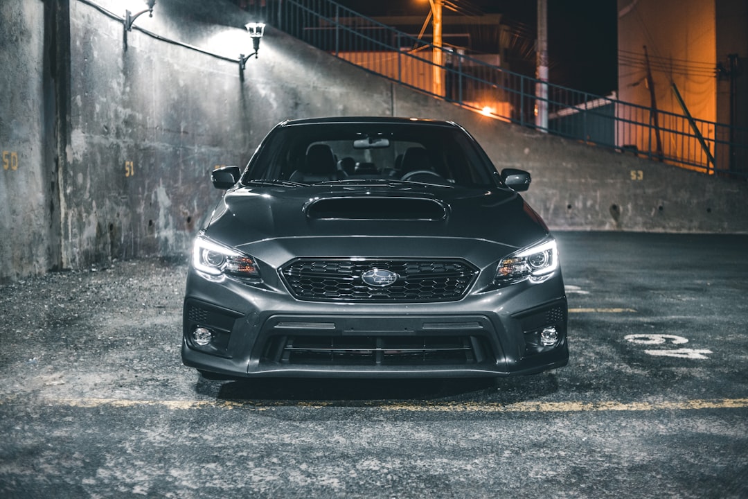 black bmw car parked on gray concrete floor