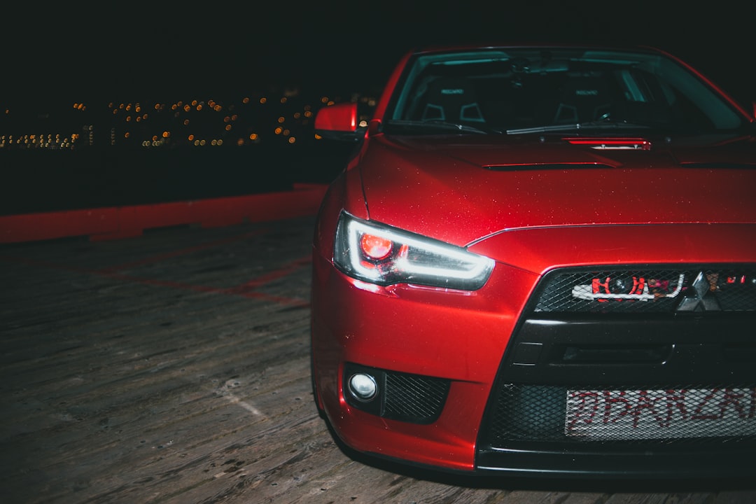 red car on road during night time