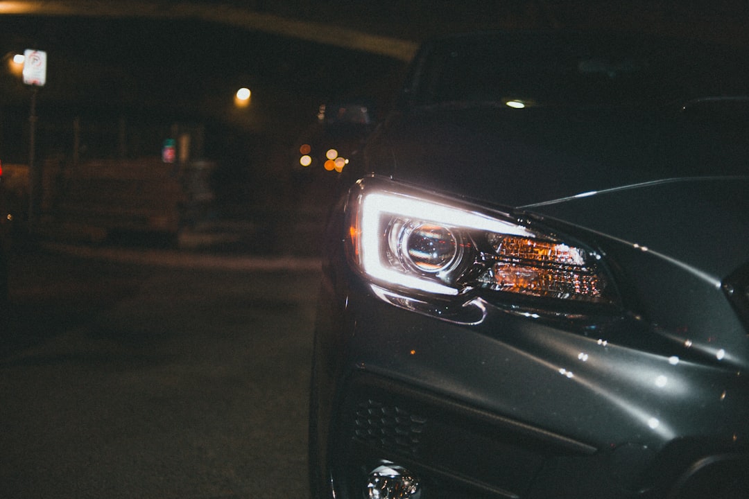 black car on road during night time