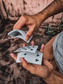 A dealer shuffling cards at a blackjack table.