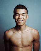 topless man smiling in front of the camera