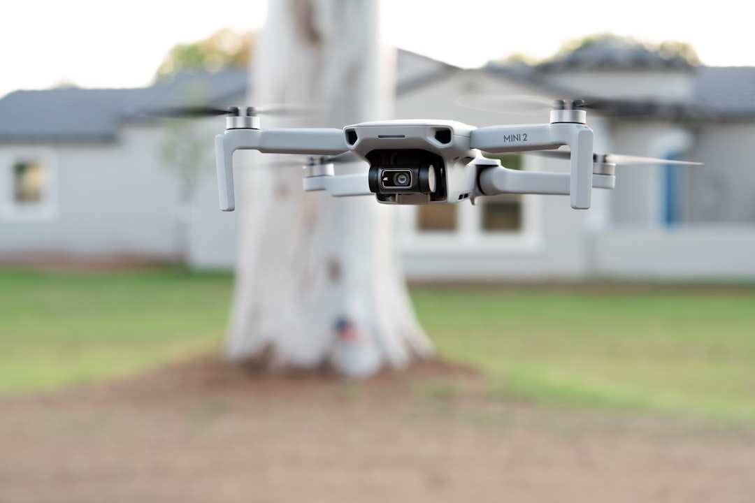 white and black drone on white pipe