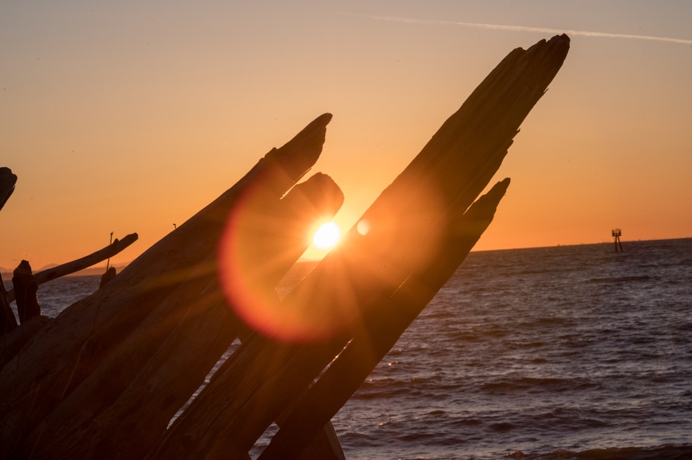 silhouette of ship on sea during sunset