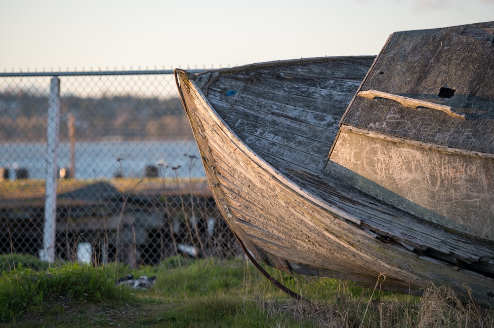 brown wooden canoe on green grass field during daytime