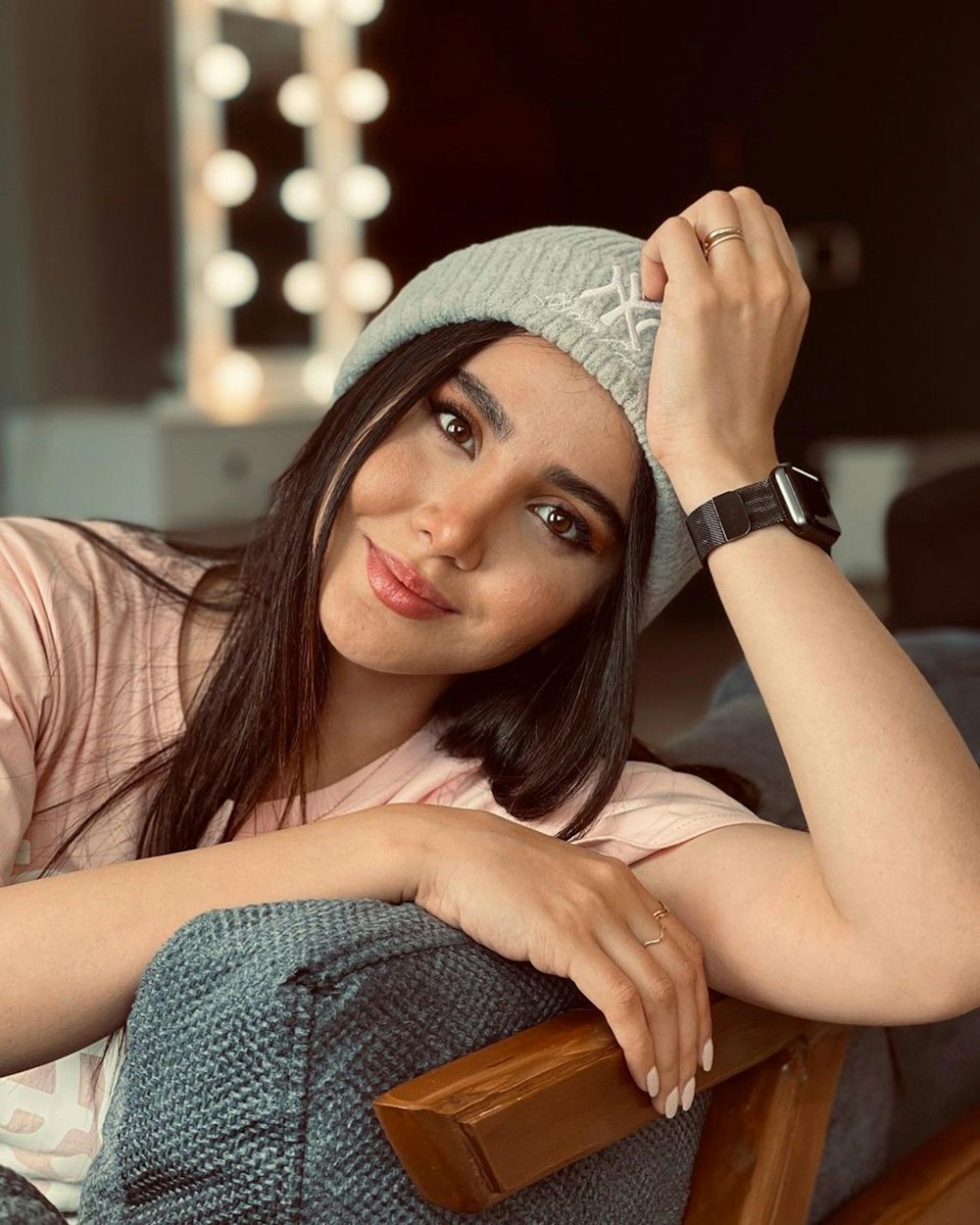 woman in gray knit cap and pink shirt