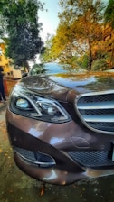 A shiny, well-maintained luxury car parked in a scenic urban setting.