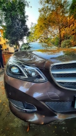 A shiny, well-maintained luxury car parked in a scenic urban setting.