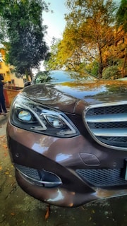 A shiny, freshly detailed car parked in a scenic outdoor setting.