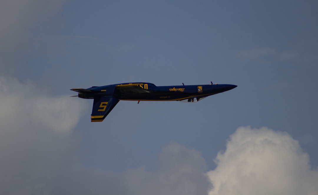 blue and yellow jet plane in mid air