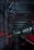 A dimly lit railway tunnel with complex metal structures and piping along the walls. The interior is marked with red and white lighting, and the perspective creates a sense of depth as the tunnel recedes into darkness. The ceiling is lined with structural supports and cables.